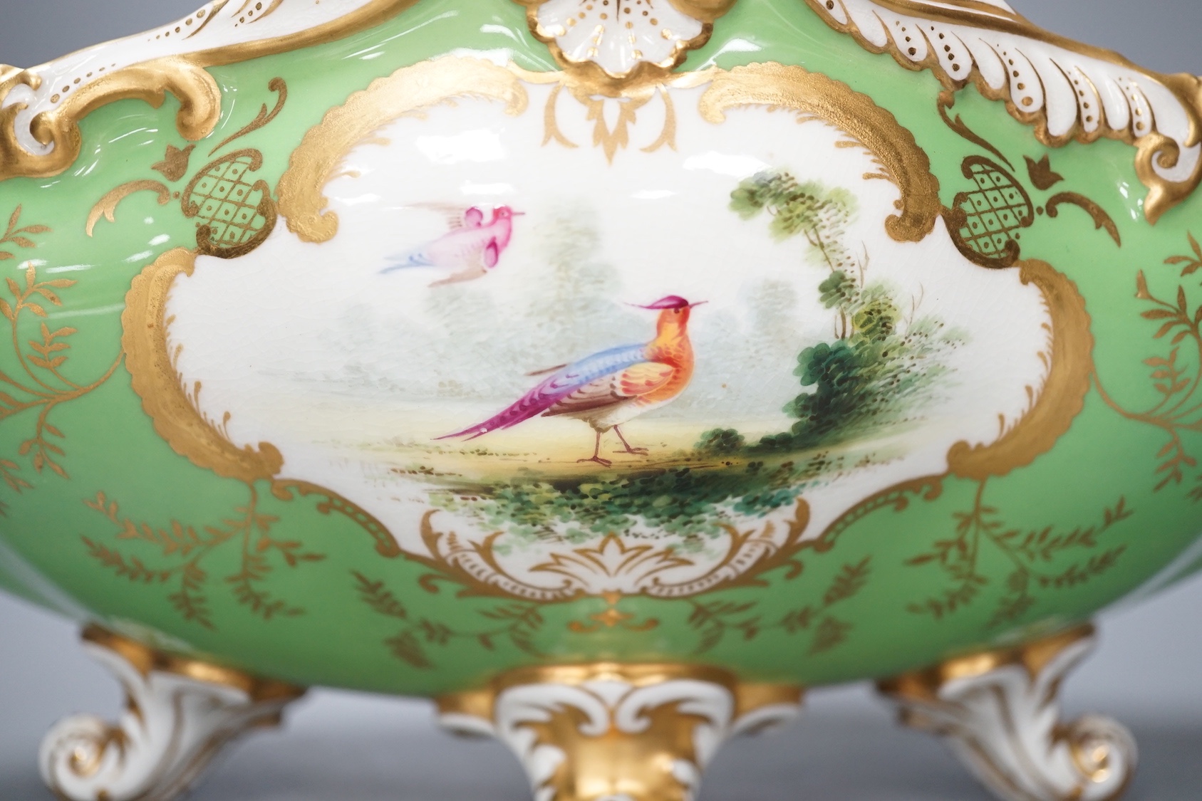 A Coalport twin handled boat shaped vase painted with a bird in panel on a lime green ground, c. 1900, 33cm